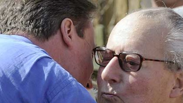 Britain's Prime Minister David Cameron embraces his father.
