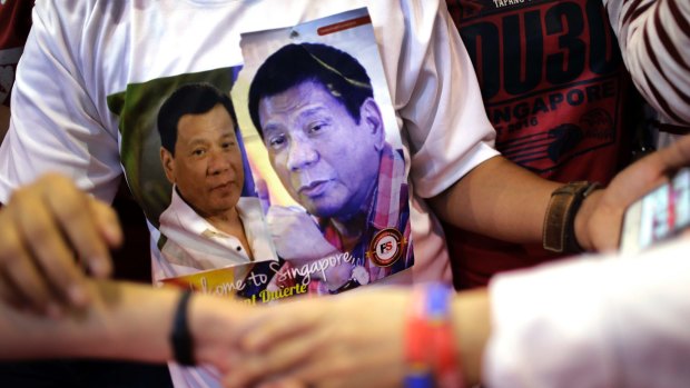 A Filipino supporter wears a T-shirt with pictures of Philippine President Rodrigo Duterte.