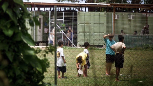 Asylum seekers at Lombrum Naval Base, Manus Island. Shipping containers surrounded by cladding and fitted with air-conditioners are their accommodation.