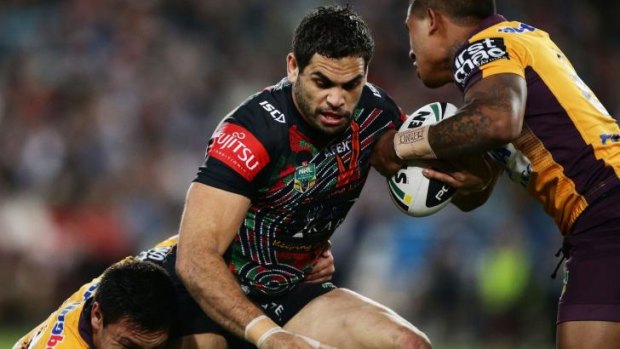 Unstoppable: Greg Inglis takes on the Broncos defence.