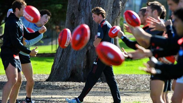 Under seige: James Hird coaches Essendon players at training on Wednesday.