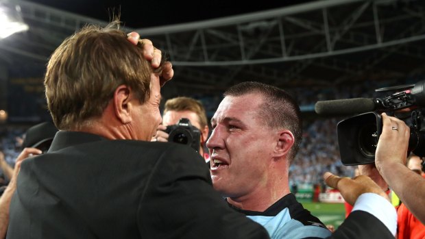 Warrior: An exhautsed Paul Gallen celebrates with Andrew Ettingshausen after winning the grand final.