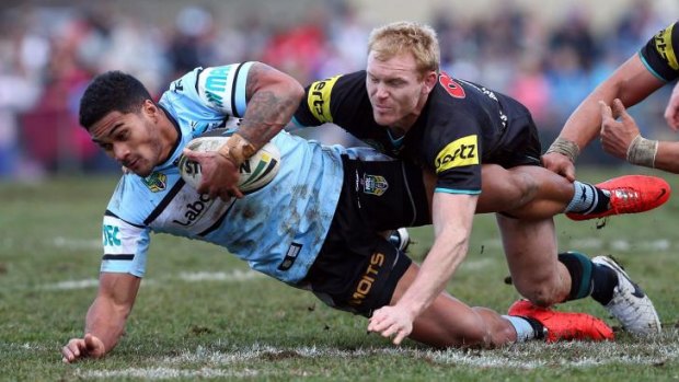 Commitment: Panthers captain Peter Wallace tackles Sharks player Ricky Leutele in Bathurst.