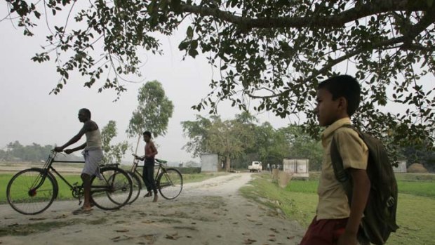 Dividing line &#8230; a boy sits on the stone cairn that separates the Bangladeshi exclave of Masaldanga from India.