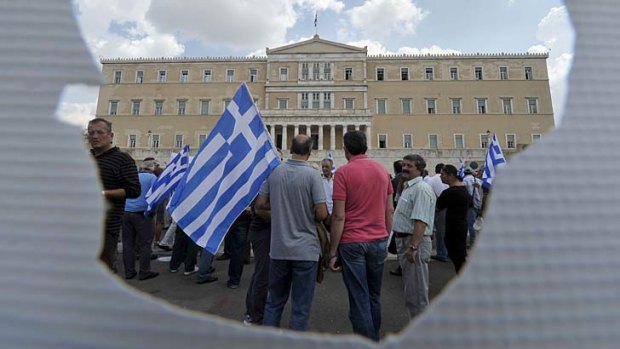 Retired military staff line up outside the Greek  parliament in Athens to protest against the latest austerity measures, including new pension cuts.
