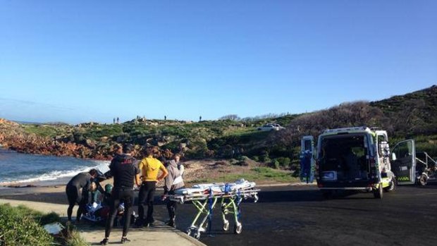 Justin Holland receives medical attention after he wiped out at famous Gracetown surf break 