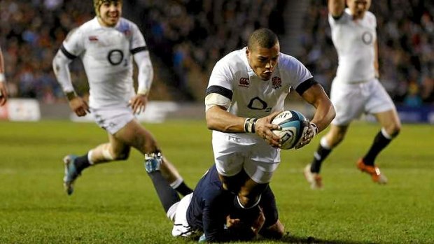 Try time: England's Luther Burrell scores a try as Scotland's Greig Laidlaw attempts a tackle during their Six Nations match at Murrayfield.