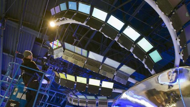 Rigger Matt Gerbracht looks over a display of Ultrabooks powered with Intel processors as workers prepare for the International CES show at the Las Vegas Convention Centre.