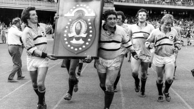 Spoils of war: Manly players embark on a lap of honour with the trophy (having swapped shirts with their opponents).