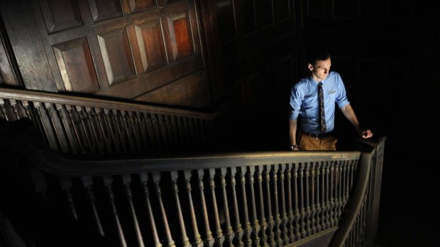 Faded glory ... heritage consultant Rupert Mann on the teak staircase of the derelict colonial era Pegu club.