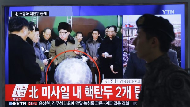 A South Korean soldier watches North Korean leader Kim Jong-un with superimposed letters that read: "North Korea's nuclear warhead".