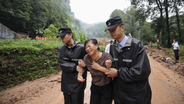 A woman grieves for a relative killed in a landslide in Dujiangyan, Sichuan Province, on Friday.