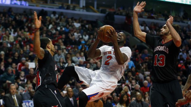 New York Knicks point guard Raymond Felton tries to shoot between Chicago Bulls point guard D.J. Augustin and centre Joakim Noah.