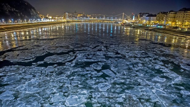 Ice floes float in the water of River Danube at the Szabadsag (Freedom) Bridge in Budapest, Hungary. 