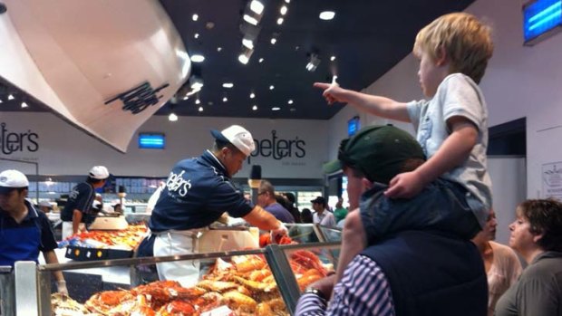 Families line up for seafood at Peter's Fish Market at the Sydney Fish Market.