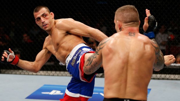 George Sotiropoulos (left) kicks Ross Pearson during their UFC lightweight bout on the Gold Coast in December.