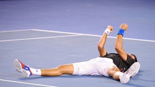 Novak Djokovic collapses on the ground after defeating Rafael Nadal to win the 2012 Australian Open men's final.