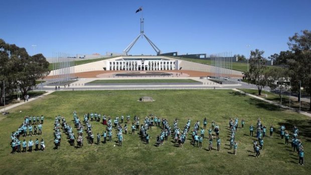 More than 350 young Australians form the words End Poverty on the lawns in front of Parliament House.