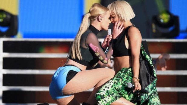 Iggy Azalea has a near kiss with Rita Ora, while performing <i>Black Widow</i> at the Budweiser Made In America Festival.