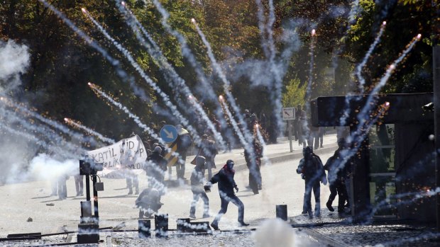 Kurdish demonstrators clash with riot police outside of the Middle Eastern Technical University (METU) in Ankara over Turkey's inaction on Kobane.