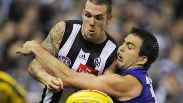 Collingwood's Dane Swan fights for the ball with  Bulldog defender Brian Lake  during their clash at Etihad Stadium yesterday afternoon that saw the Pies come out on top.