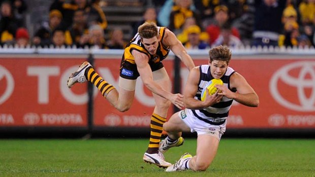 Geelong's Tom Hawkins marks with moments to go in front of Hawthorn's Ryan Schoenmakers.