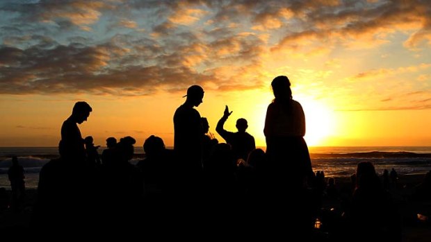Not so wild ride: Revellers watch the sun rise at Surfers.