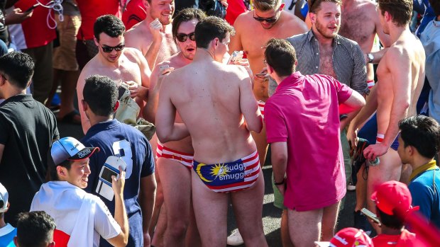 Nine Australian revellers at Malaysia's formula 1 racing circuit have been jailed after stripping down to reveal underpants themed on Malaysia's national flag. 