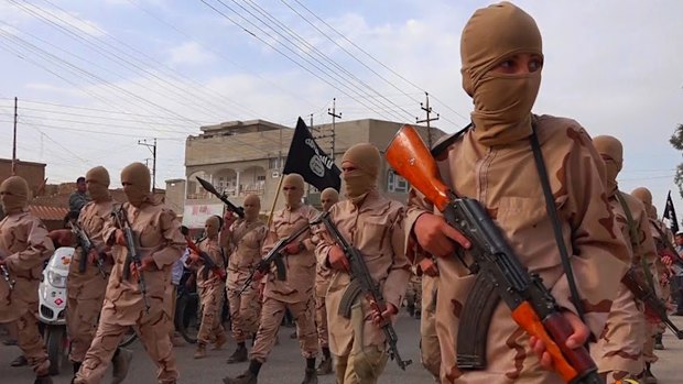 An Islamic State propaganda website shows youth units known as the "lion cubs" holding rifles during a parade after graduating from a religious school in Tel Afar, near Mosul, northern Iraq. 