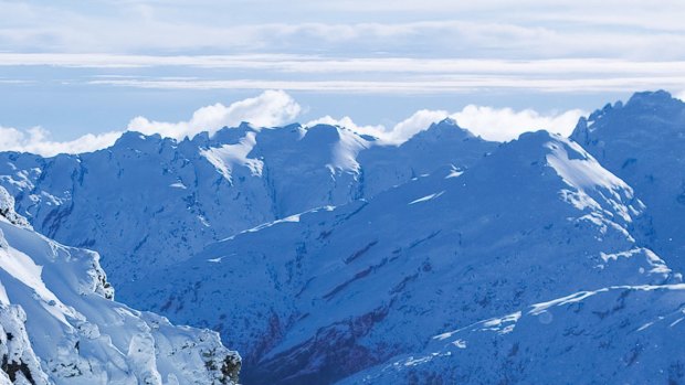 Snowboarding soft powder high in the Southern Alps.