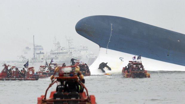 Rescue workers surround the ship as it sinks.