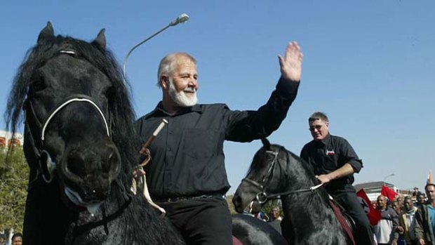 South African white supremacist Eugene Terre'Blanche  rides a black horse after being released from prison in Potchefstroom  on June 11, 2004.