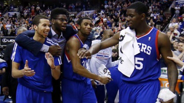 Drought-breaker: Philadelphia 76ers players  Michael Carter-Williams, Nerlens Noel, Hollis Thompson and Henry Sims celebrate in the final seconds of the win over Detroit in March which broke a 26-game losing streak.