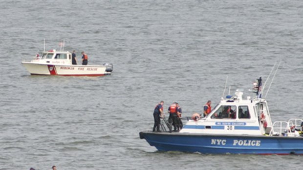 No survivors ... a body is retrieved from the Hudson River as divers search the murky water after the crash.