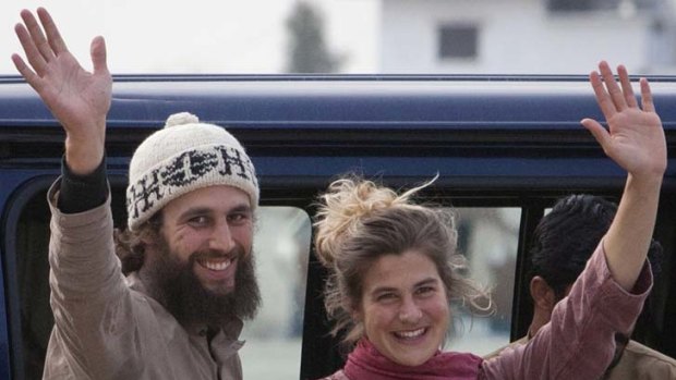 Swiss nationals Olivier David Och and Daniela Widmer wave to the media at a military base near Islamabad.