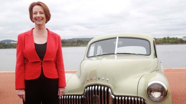 Prime Minister Julia Gillard with the first Holden that came off the line in 1948.