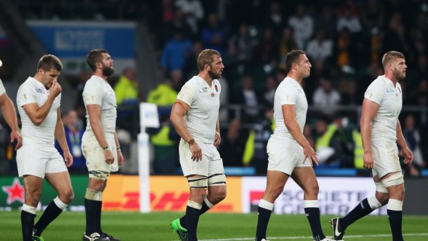 Dejected: The England team after their loss to the Wallabies.