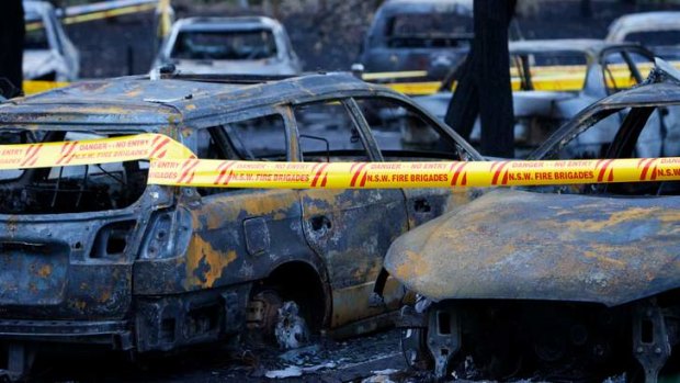 Destruction: burnt vehicles remain parked at Homebush Aquatic Centre.