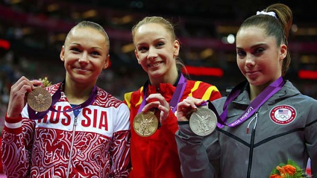 Silver medallist McKayla Maroney, right, stands with gold medallist Sandra Raluca Izbasa, centre, of Romania and bronze medallist Maria Paseka of Russia.