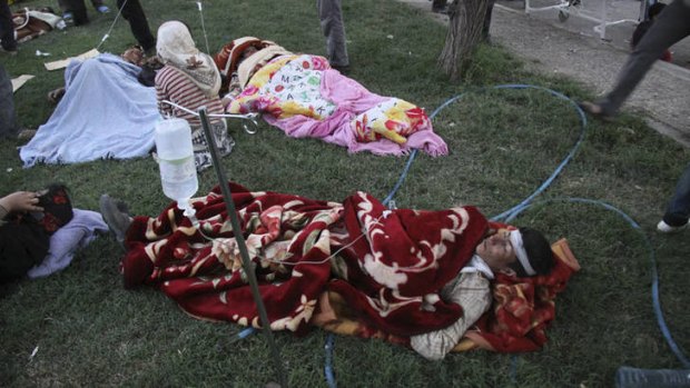 Victims are tended in a hospital courtyard after an earthquake hit the city of Ahar, northwestern Iran.