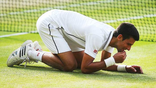 Novak Djokovic celebrates his triumph by eating some of the centre court grass.