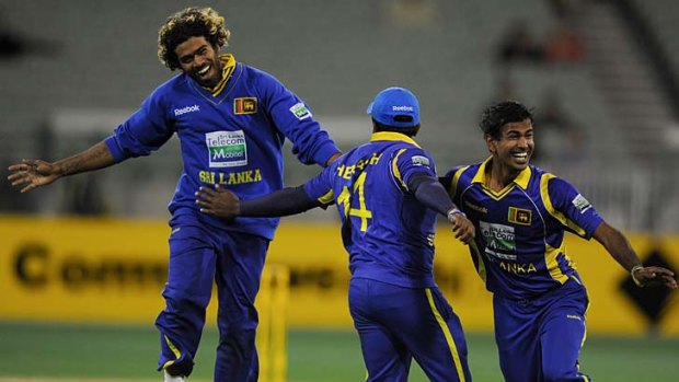 Winning feeling: Sri Lankans Lasith Malinga, Rangana Herath and Nuwan Kulasekara celebrate their win over Australia at the MCG last night.