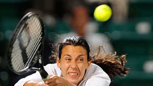 Marion Bartoli stretches to effect a return.
