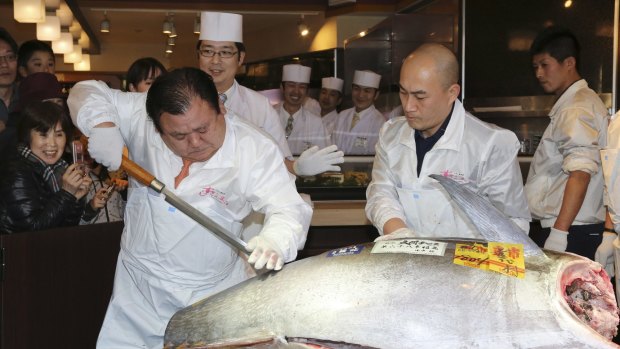 Kiyoshi Kimura cuts the massive tuna at his Sushi Zanmai restaurant.