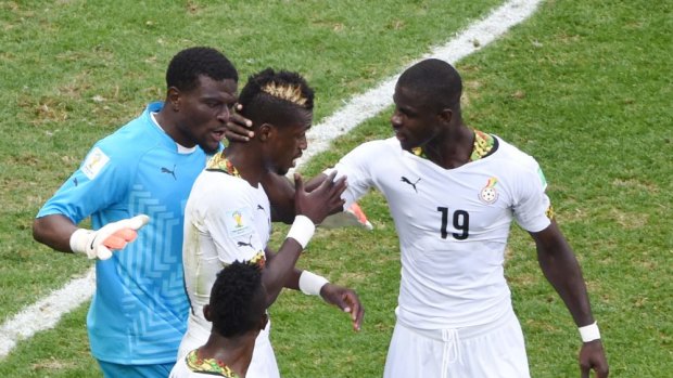 It's okay ... Ghana's defender John Boye (centre) is consoled by teammates after scoring an own goal against Portugal. He was filmed kissing the $US3 million sent by Ghana's President before the game.