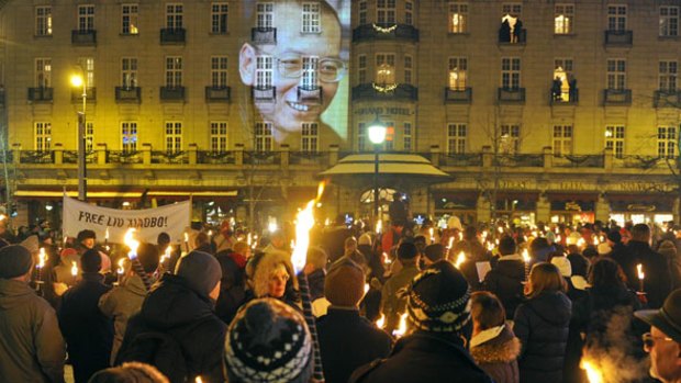 An image of Liu Xiaobo is projected onto the wall of the Grand Hotel in Oslo after the Nobel peace prize ceremony.