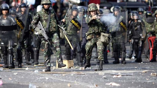 Thai soldiers fire their weapons at anti-government "red shirt" protesters during clashes in central Bangkok April 10, 2010.