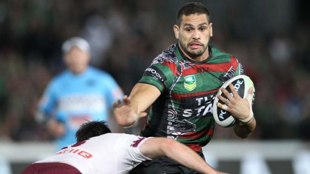 Destroyer in chief: Greg Inglis swats aside the challenge of Manly's Jamie Lyon.