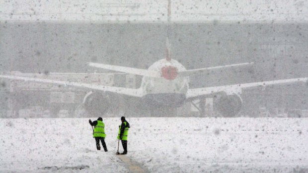 Workers try to clear snow at Heathrow Airport in December 2010.