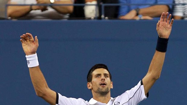 Novak Djokovic reacts after he won match point.